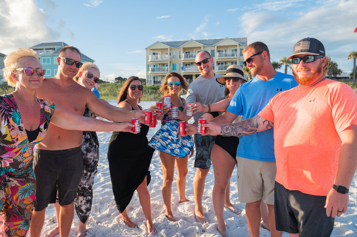 family holding up beer at Seaside Beach