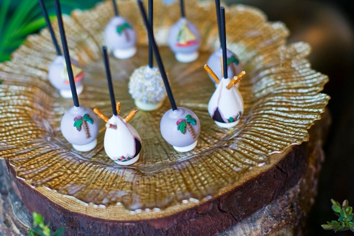 Cake pops sat on a gold charger plate