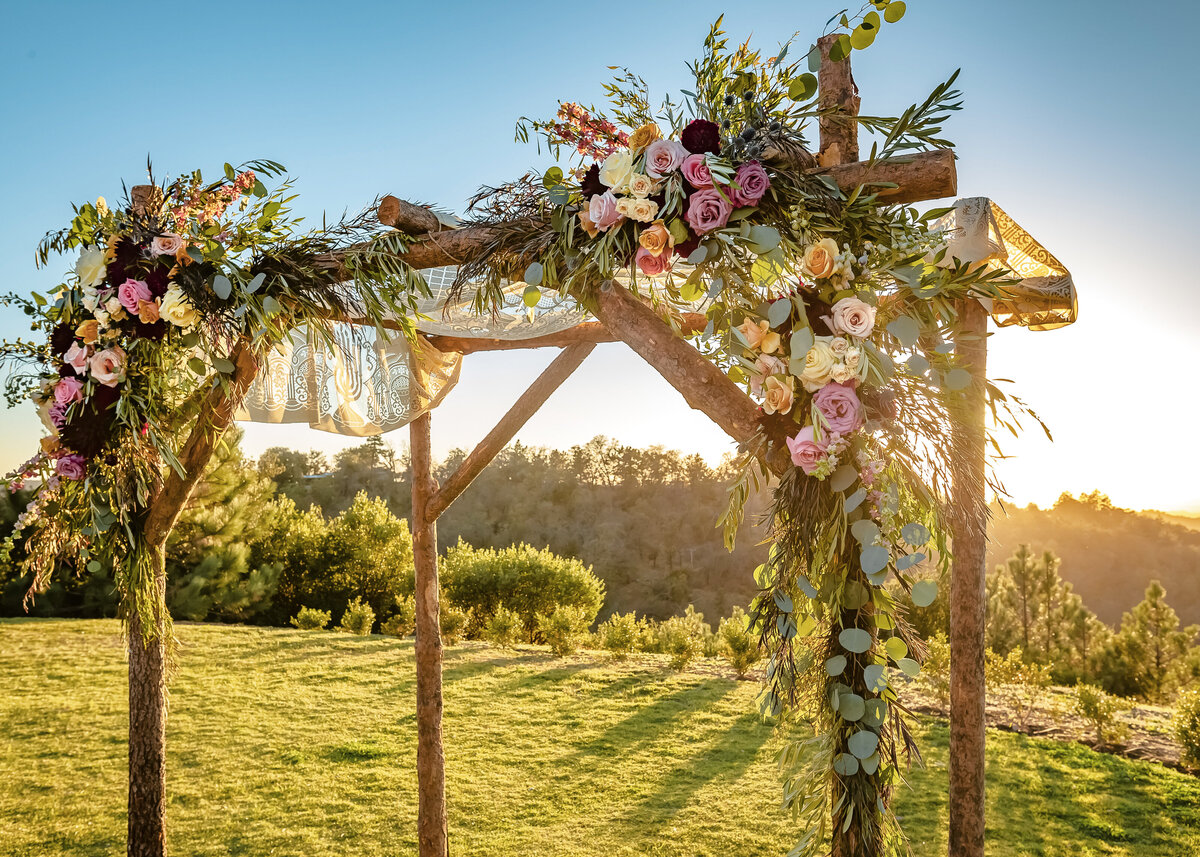 Outdoor sunset view of a Jewish traditional wedding ceremony. Wedding canopy chuppah or huppah.