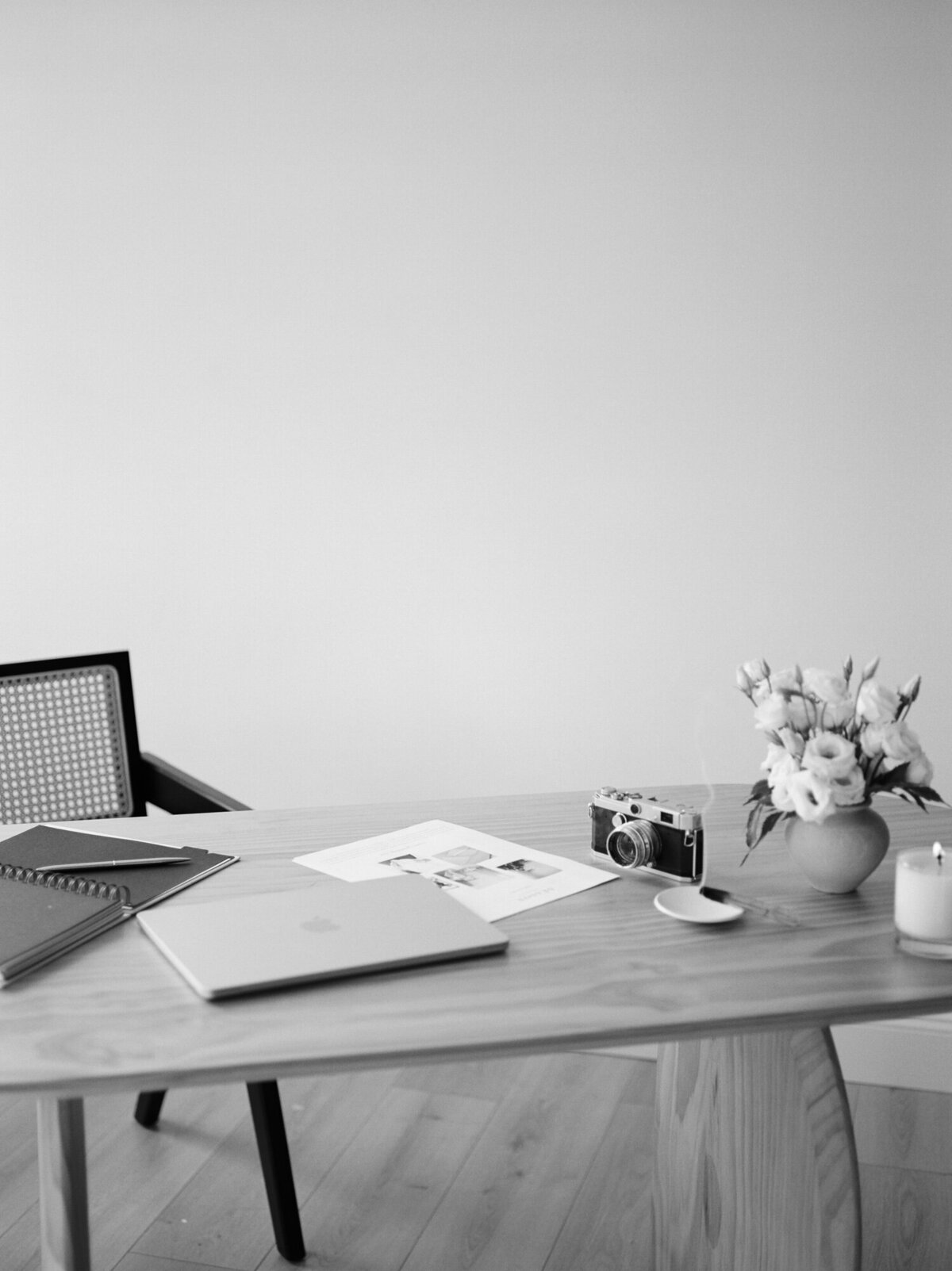 desk with camera, closed laptop, creative inspiration for film brand photoshoot near Michigan