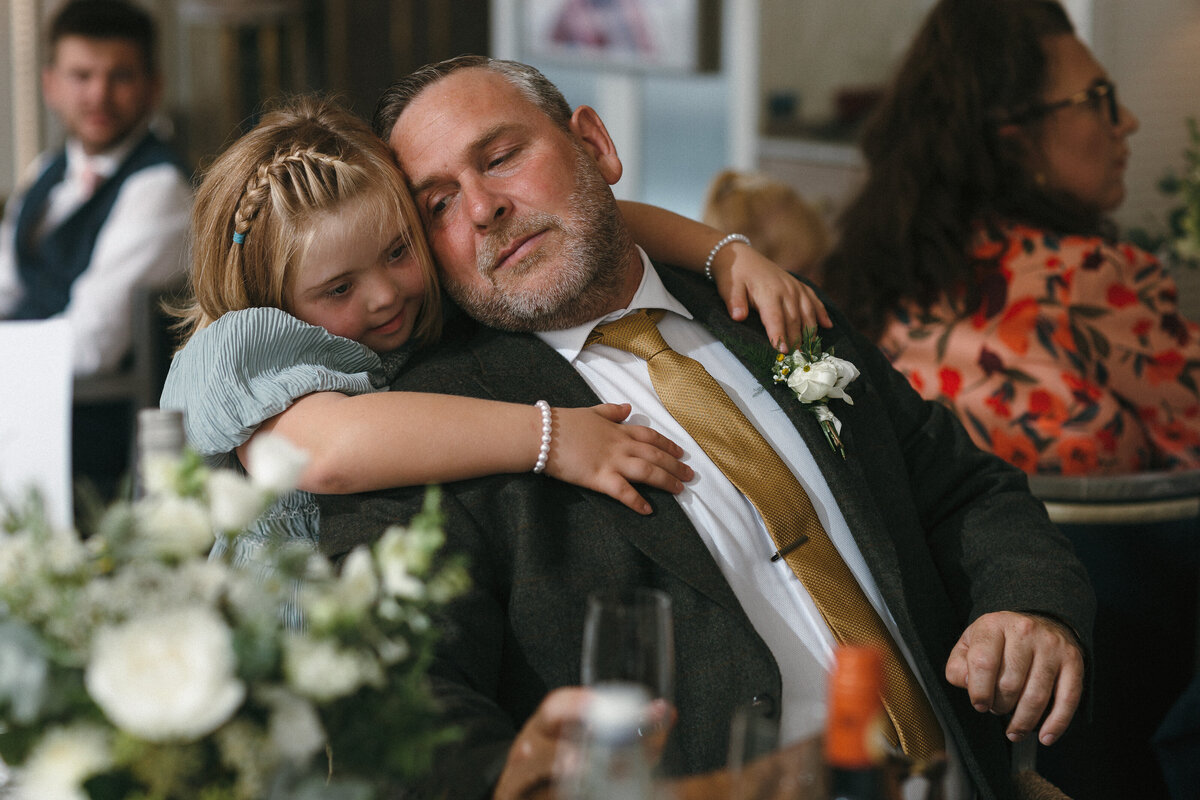 Dad and daughter embrace at wedding in Thurelstone