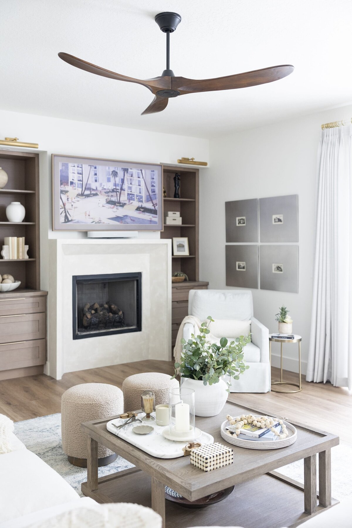 dewine design orlando interior designer belle isle living room with wood ceiling fan and white fireplace and wooden shelves