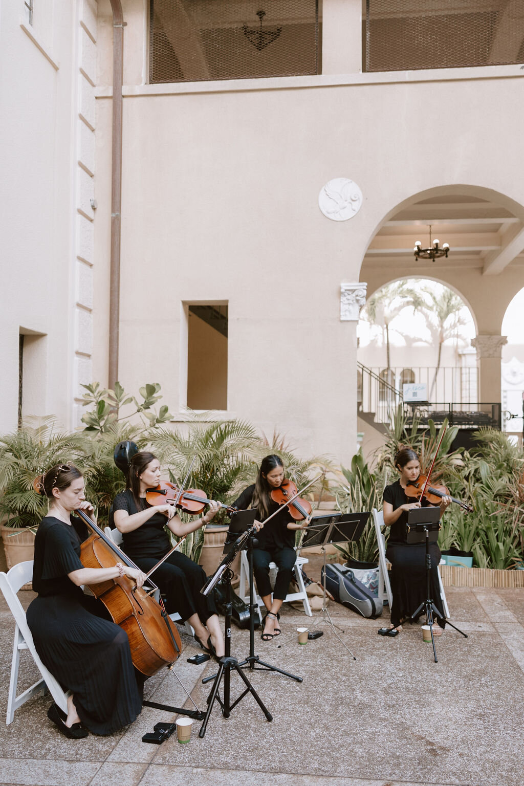 String quartet seated off to the corner of the open air courtyard