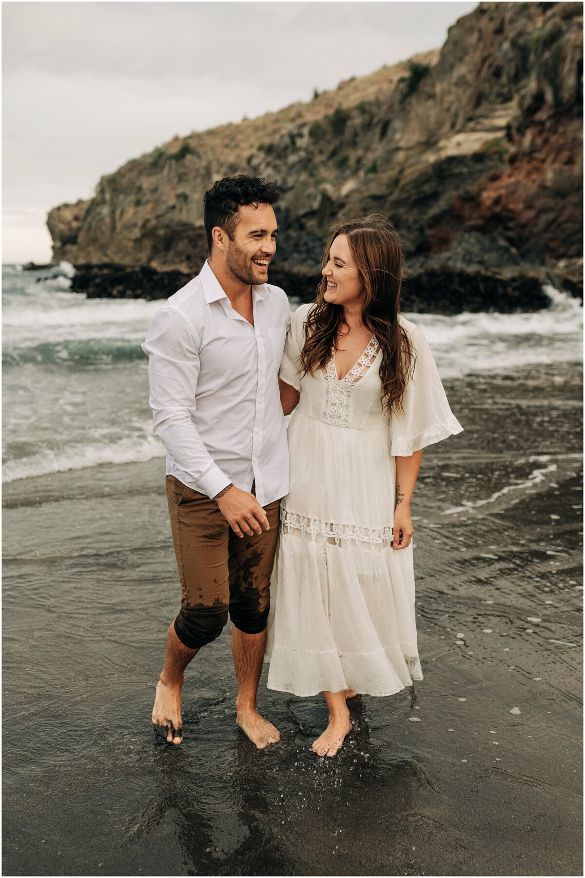 couple engaged beach taylors mistake shoot christchurch water sunset summer photographer wedding happy white dress