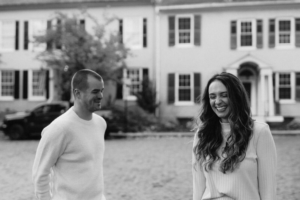 couple waking in neighborhood at Finger Lakes engagement session