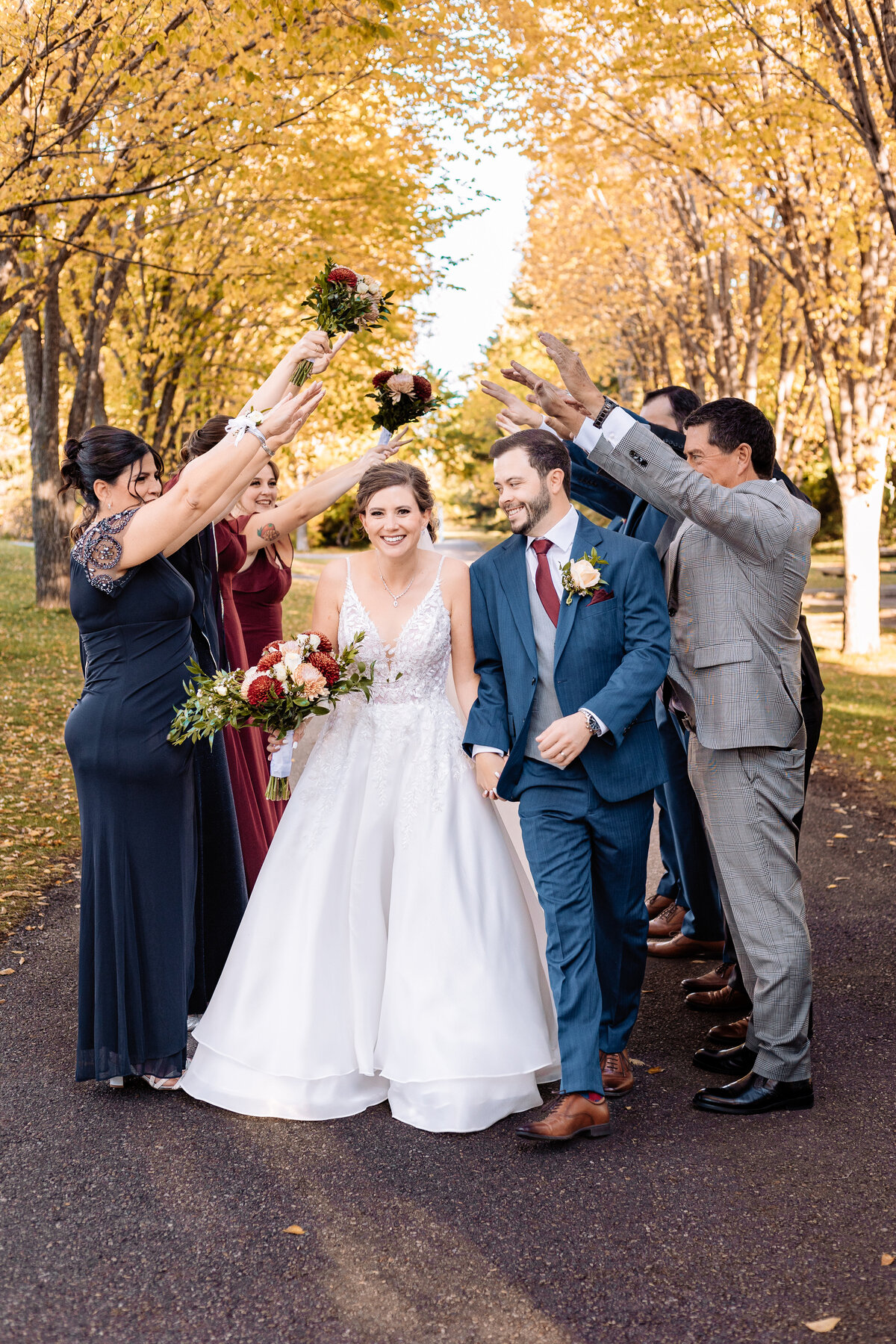 Bride and groom go through a tunnel of love made of their family and friends