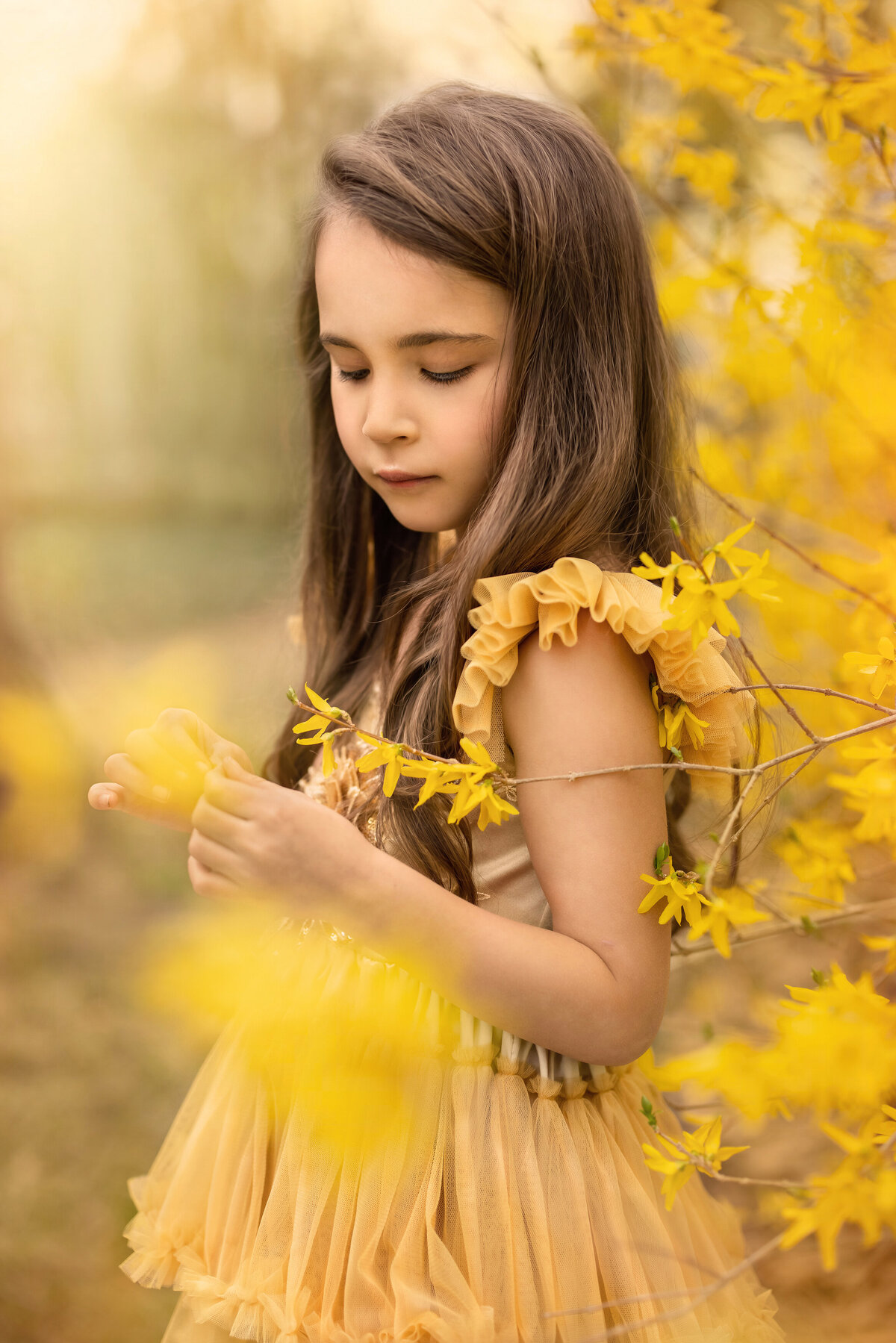 Child holds flower for artistic portraits during photography session in New Jersey