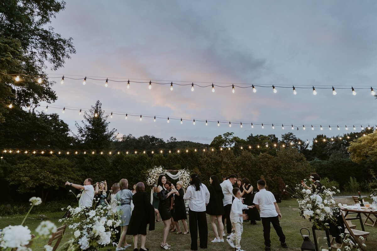 the guests dancing under a pastel skies in outdoor reception venue in seoul south korea