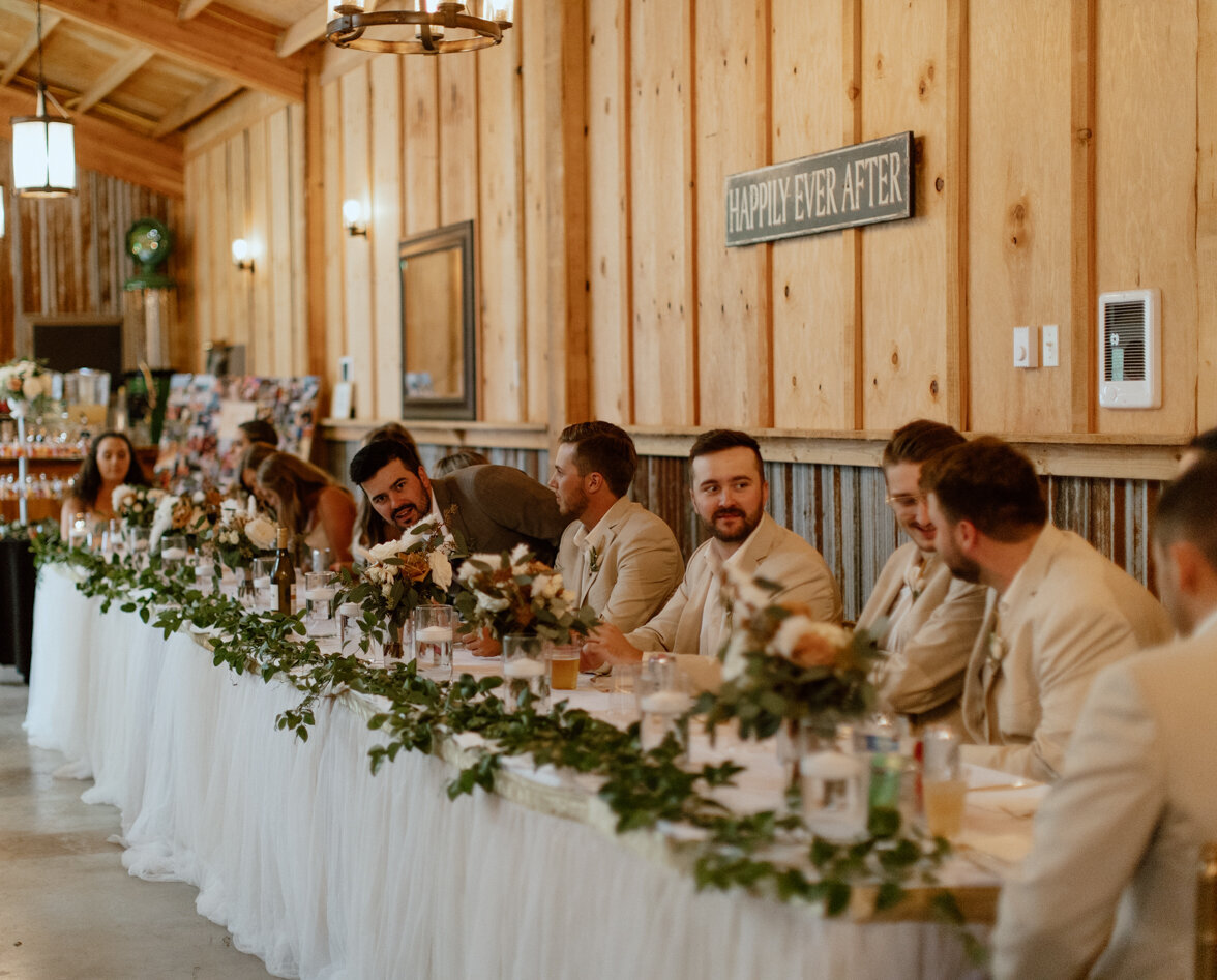 Bridal party at the headtable during the wedding reception.
