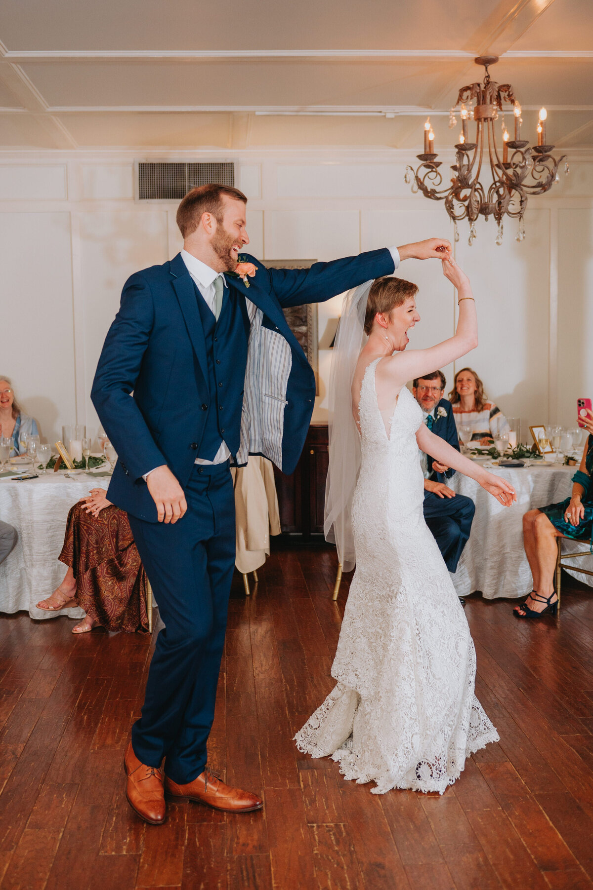 Newlyweds twirl one another while dancing