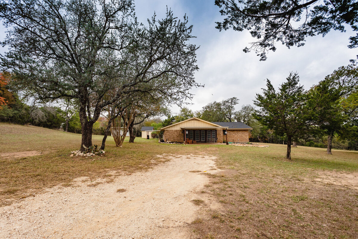Side view with large yard and covered patio at this three-bedroom, two-bathroom ranch house for 7 with incredible hiking, wildlife and views.