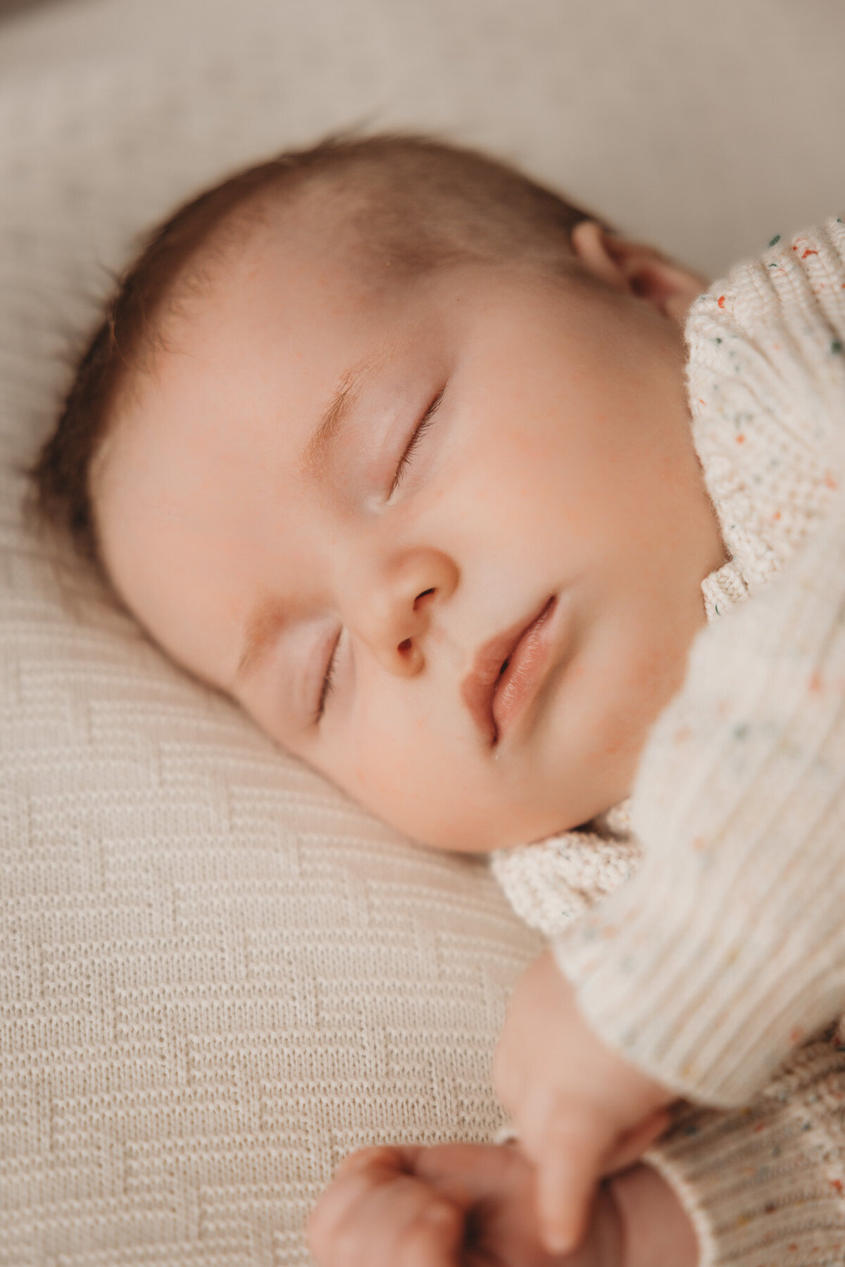 newborn baby posing on pillow captured by Bie