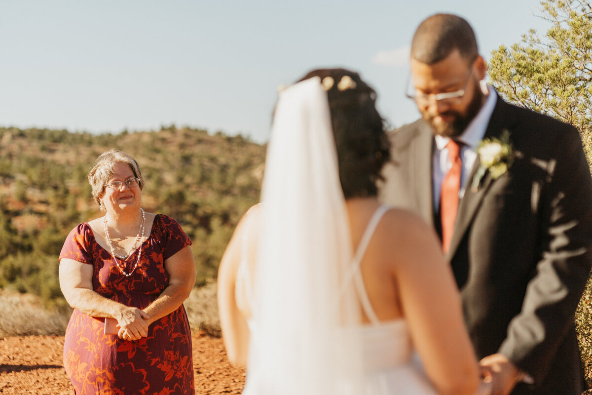 A person reading vows to their partner during their wedding ceremony. 