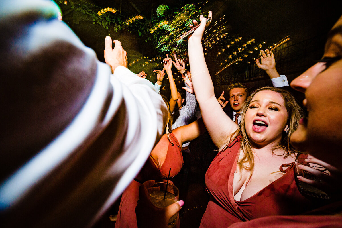 One of the top wedding photos of 2020. Taken by Adore Wedding Photography- Toledo, Ohio Wedding Photographers. This photo is of a wedding guest dancing at the wedding reception at Nazareth Hall