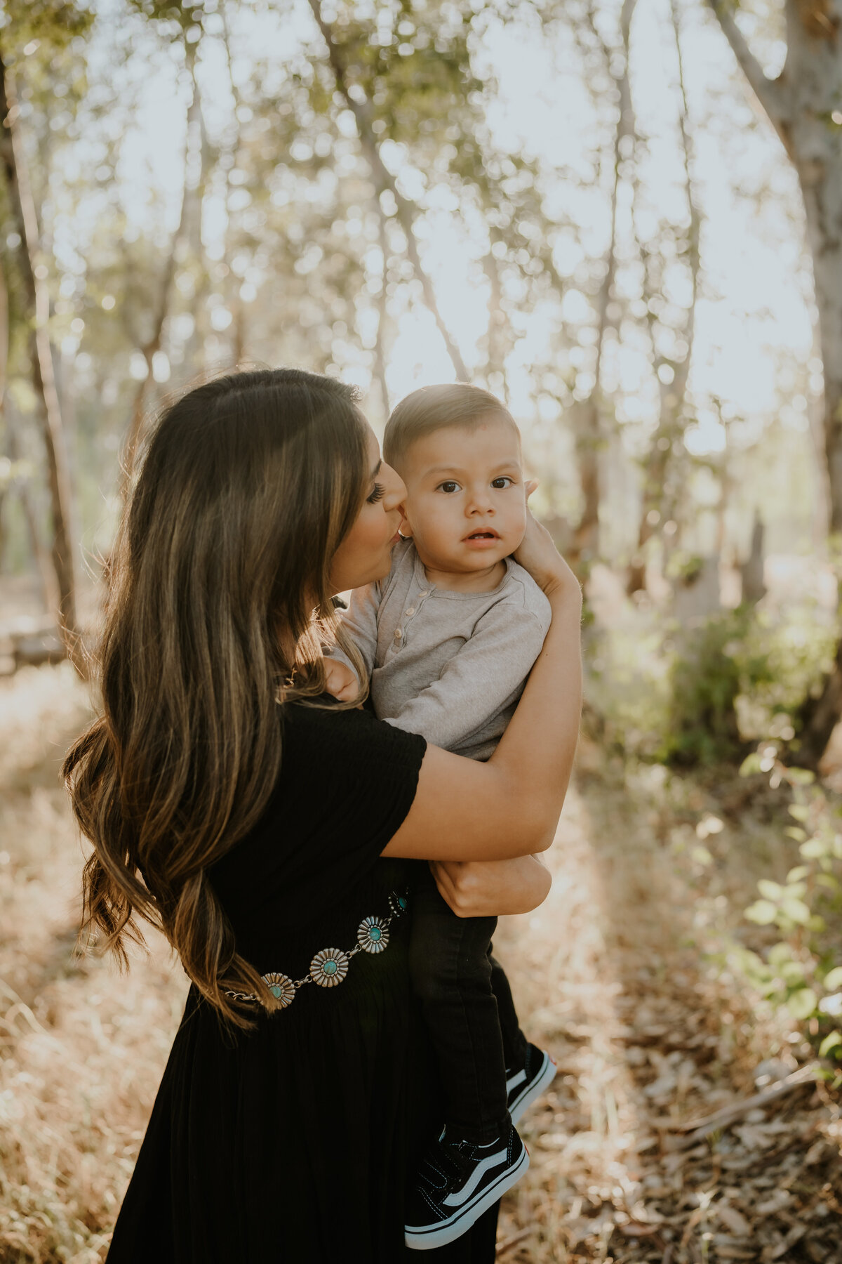 Woman kisses her small child