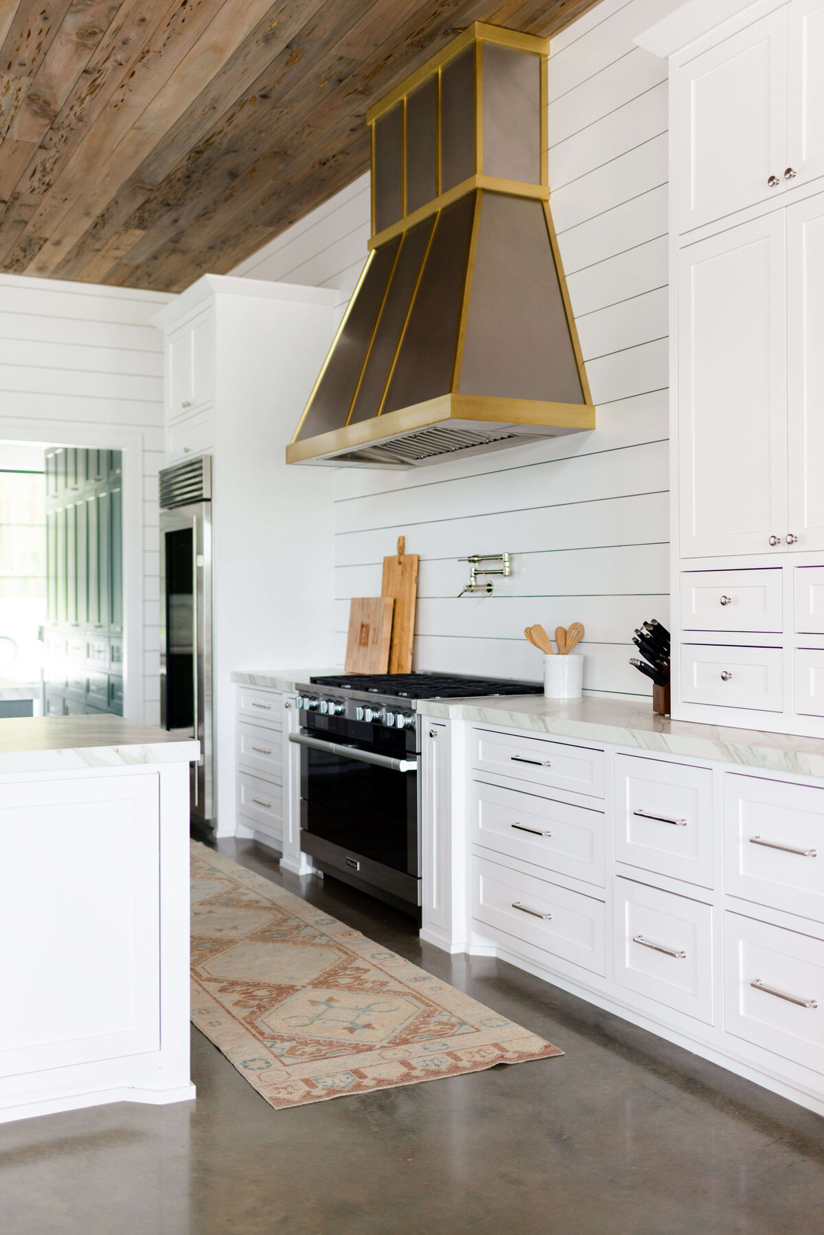 oyster creek studios building belt new build white kitchen with runner rug and shiplap ceiling
