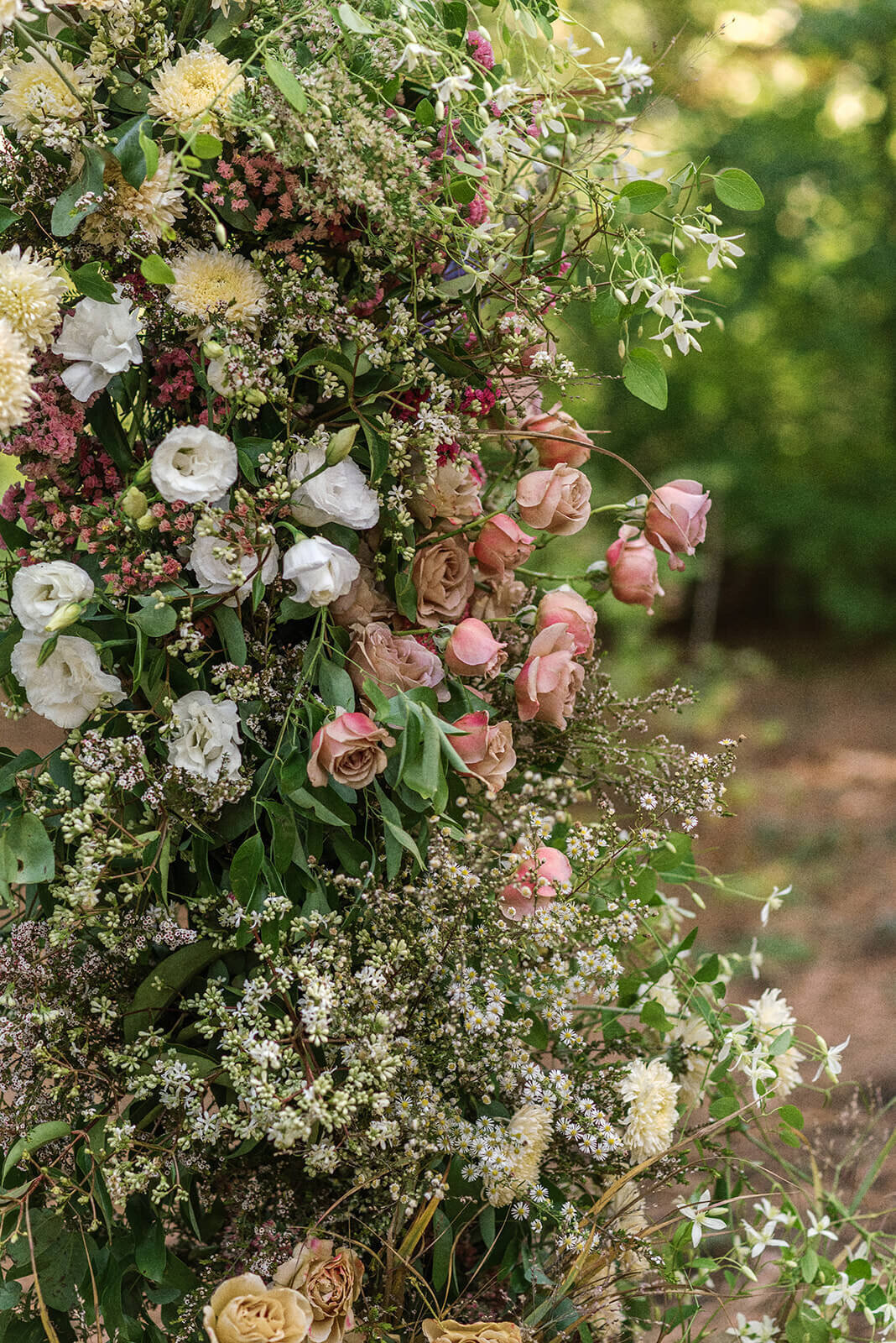 A close up of flowers that are part of a wedding installation at an outdoor wedding.