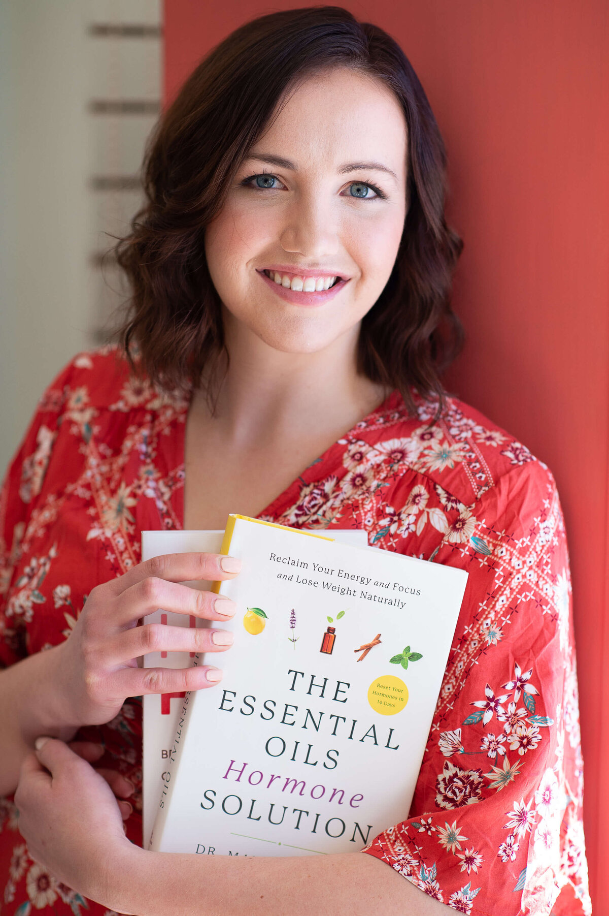 Ottawa branding photography of a yoga instructor holding books about  essential oils and hormone control