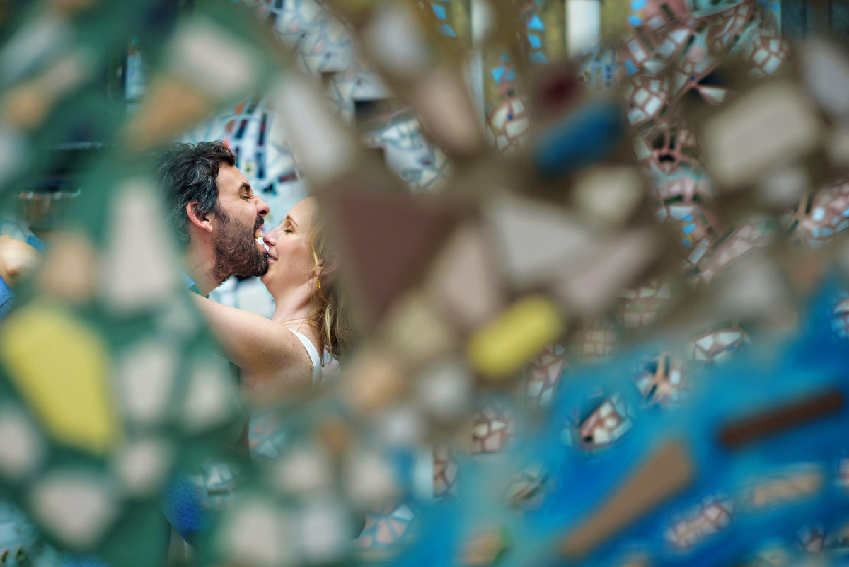 In the mirrors of the south street graffiti artist, reflects a fun engaged couple goofing around.