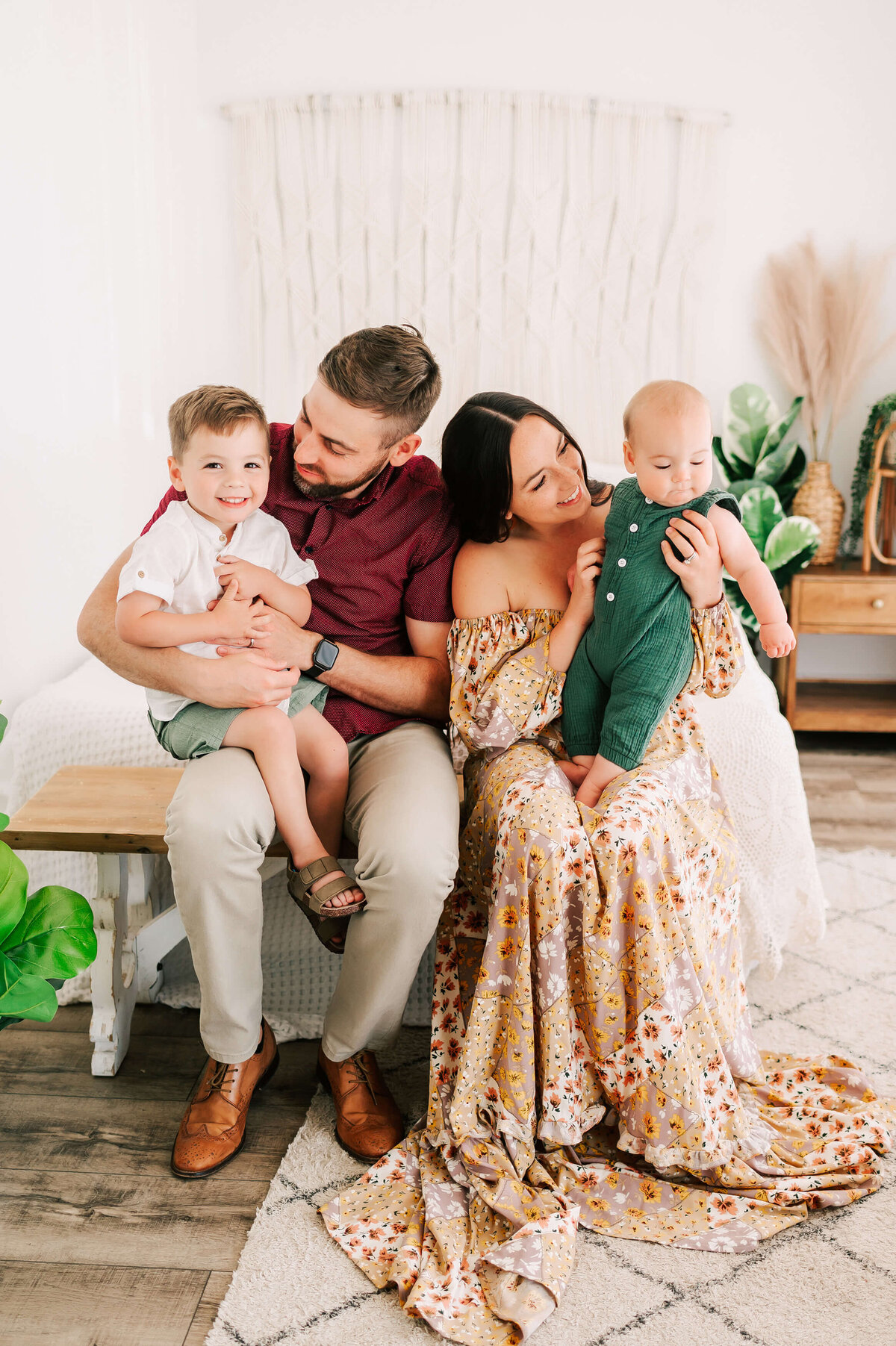 family laughing on bench during family pictures in Springfield MO