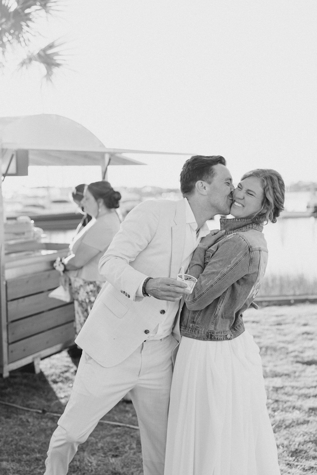 black_and_white_candid_wedding_kiss_outdoor_wedding_charleston_kailee_dimeglio_photography-1039_websize