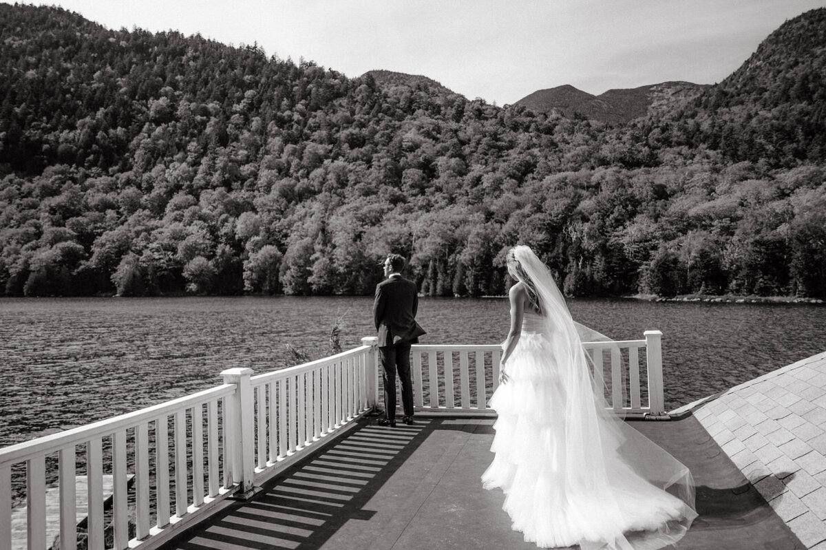adirondack-mountain-wedding-09-bride-and-groom's-romantic-walk-on-the-balcony-overlooking-the-lake-at-adirondack-mountain-wedding-jenny-fu-studio