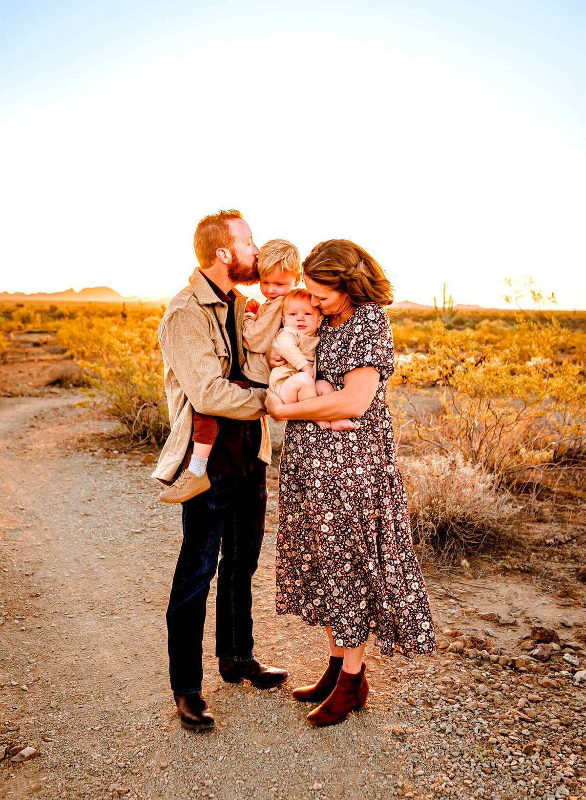 parents kissing kids for family photographer in AZ