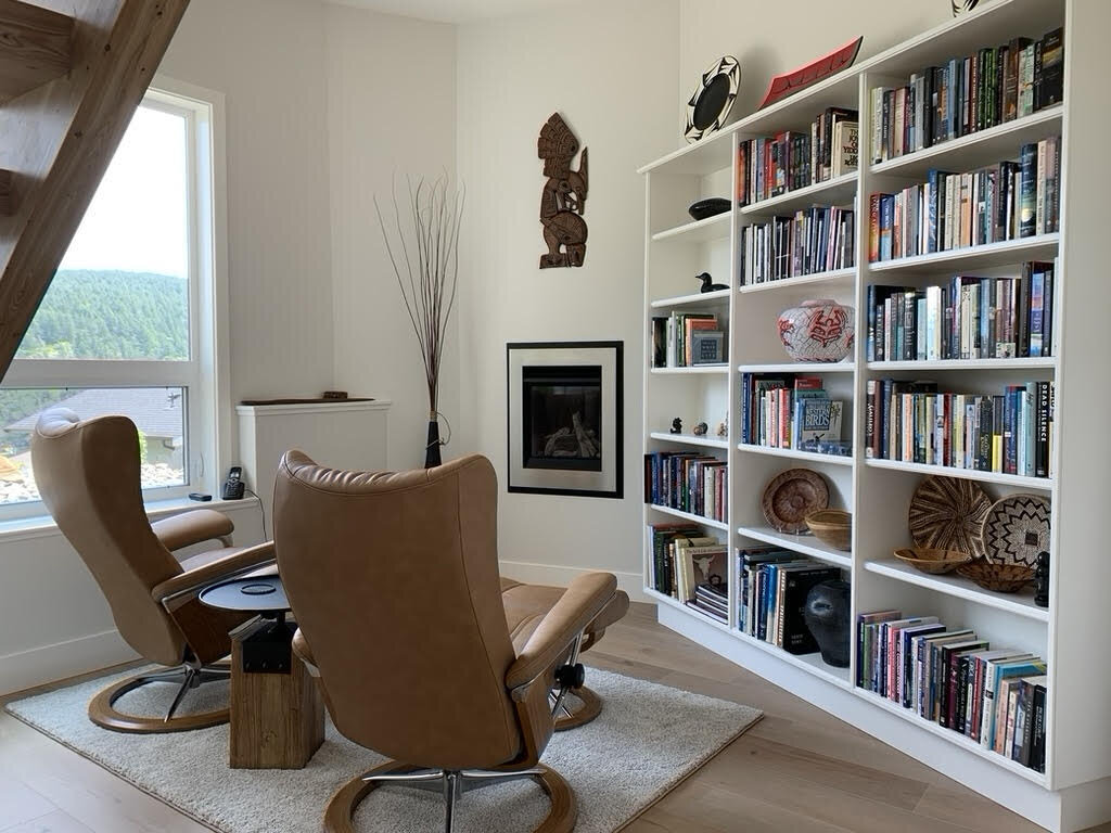 White living room with built-in bookshelves.