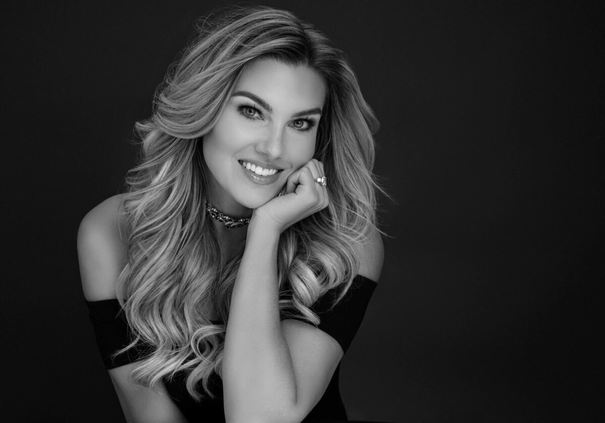 Timeless Elegance in Black and White – A captivating portrait of a confident woman. ent earrings.
