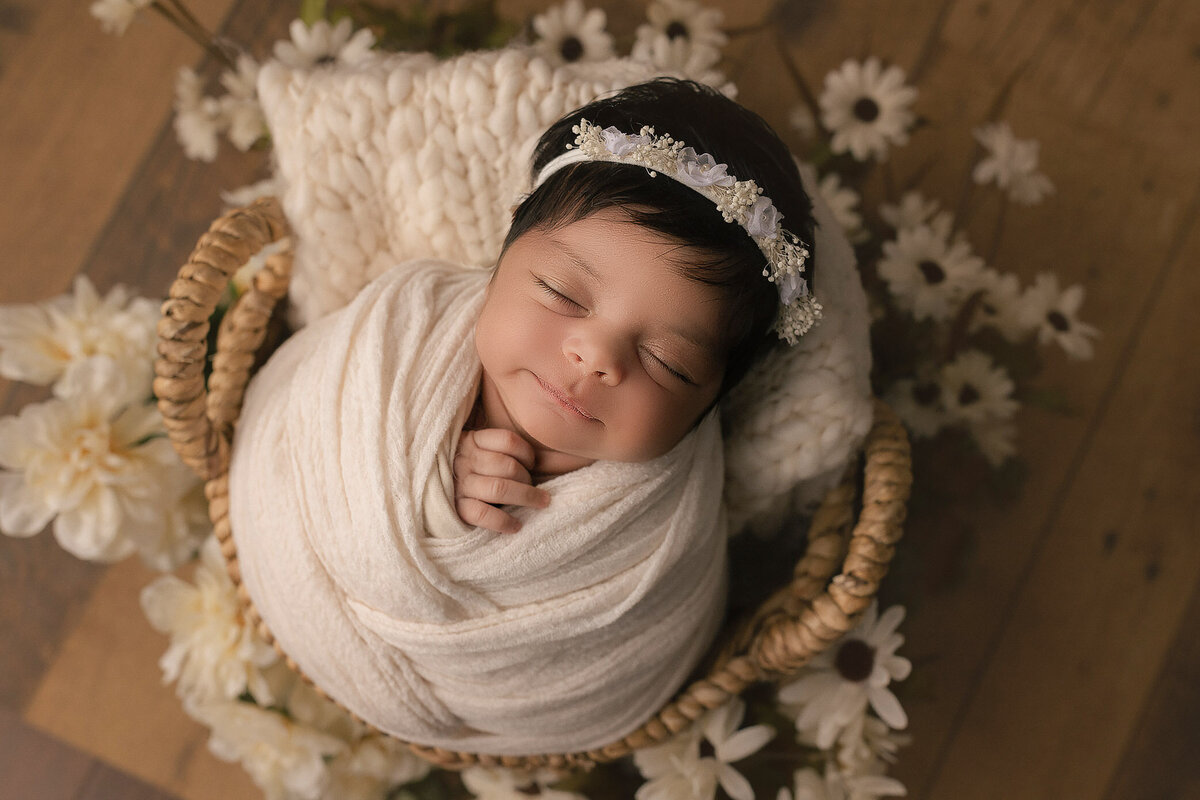 adorable baby girl smiles during her newborn photoshoot in hamilton, on