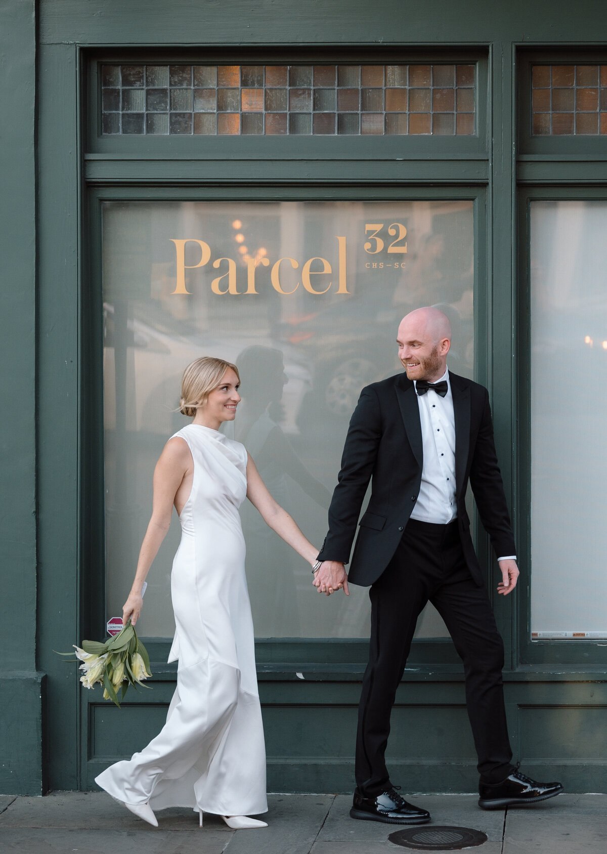 couple posing in front of parcel 32 for their wedding day