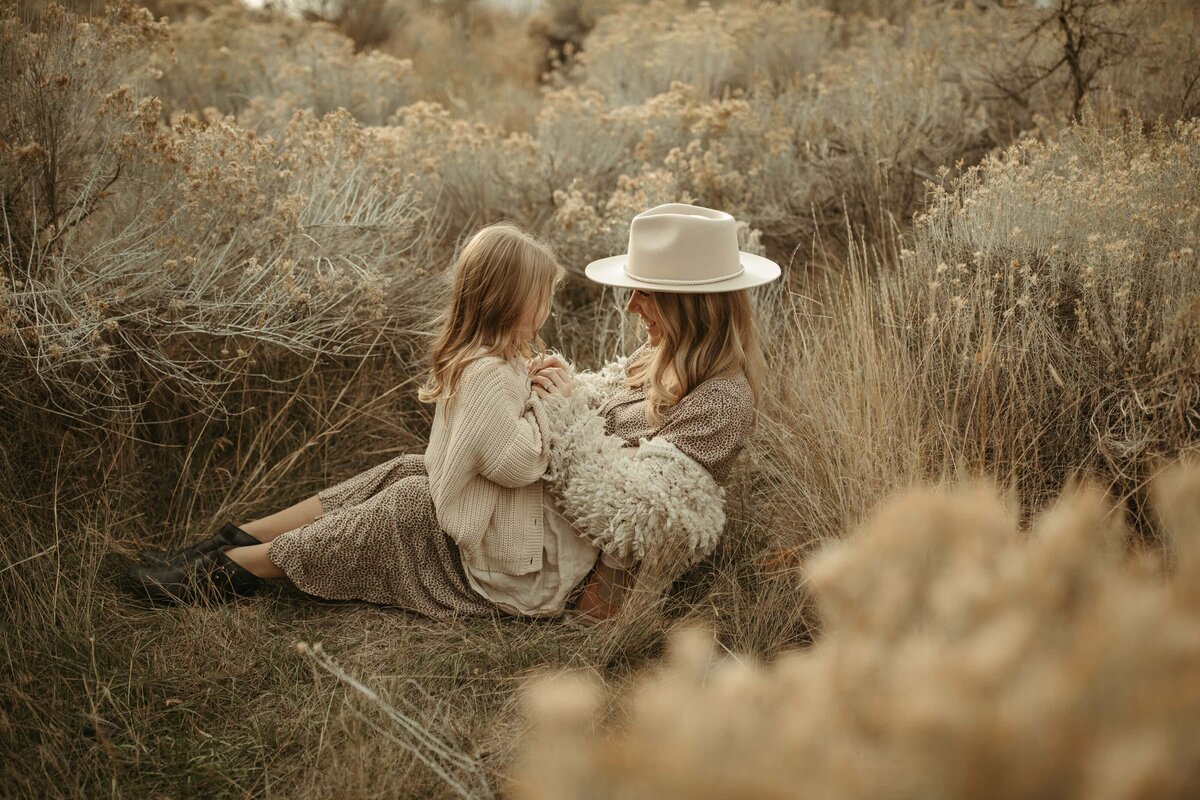 Mother and daughter sit in a field of flowers Milwaukee Wisconsin