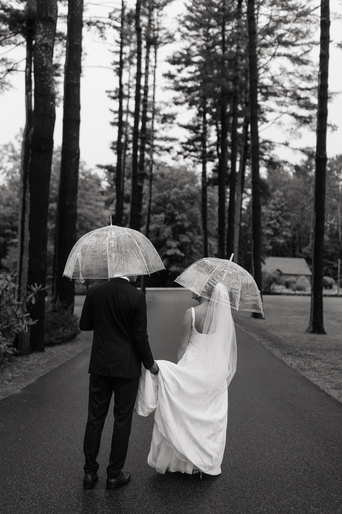 Rainy Adirondack wedding portraits with candid laughter between bride and groom