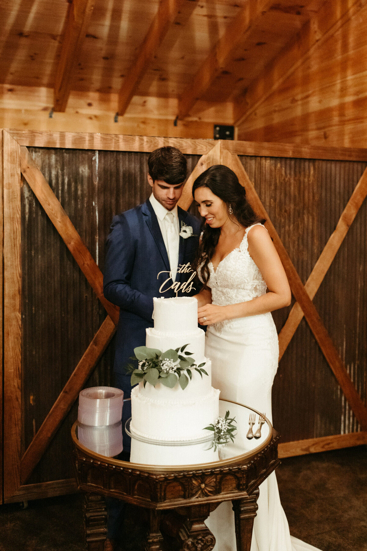 Bride and groom cutting their simple four tier wedding cake