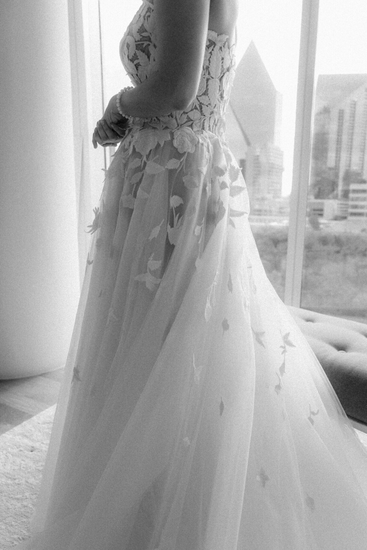 Black and white detailed image of a lace wedding gown