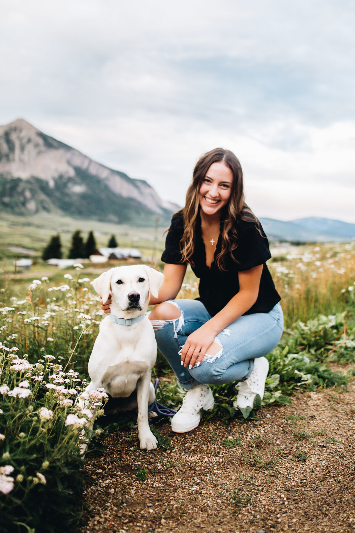 Sarah poses with her dog for her Crested Butte senior pictures.