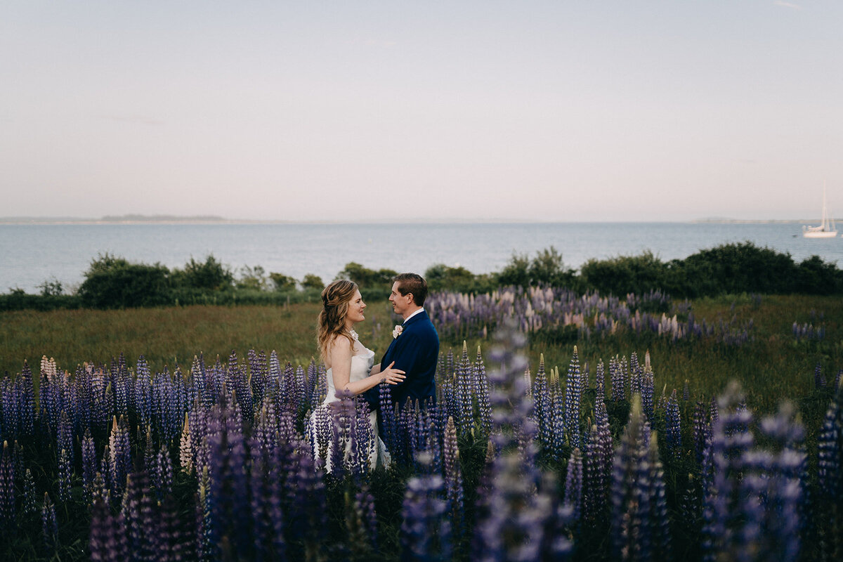 Maine couple standing outdoors at sunset in lavender field