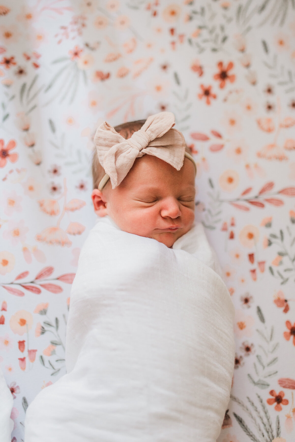 Newborn baby wearing a ribbon