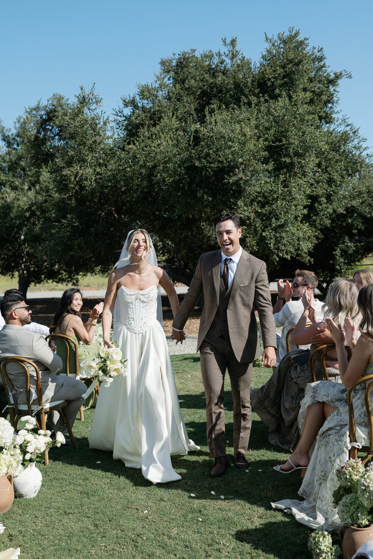 Joyful wedding party celebrating with champagne at a Southern California wedding, filled with laughter and love.