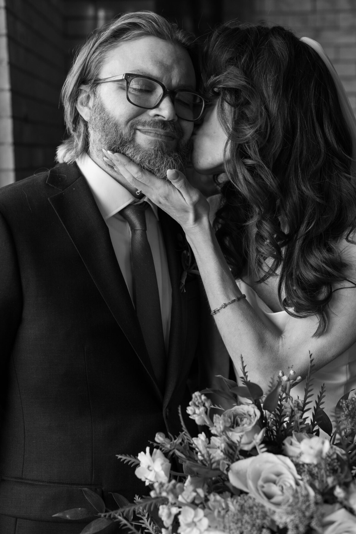 bride-kissing-groom-on-wedding-day