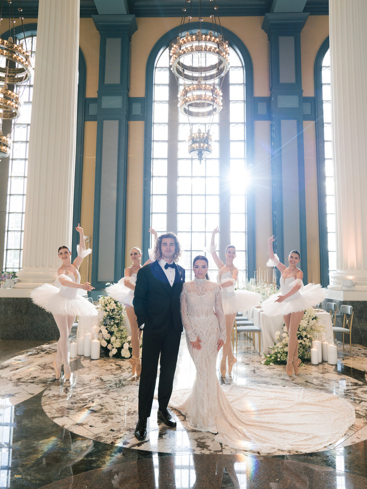 Bride and groom with ballerinas dancing at white and gold wedding reception
