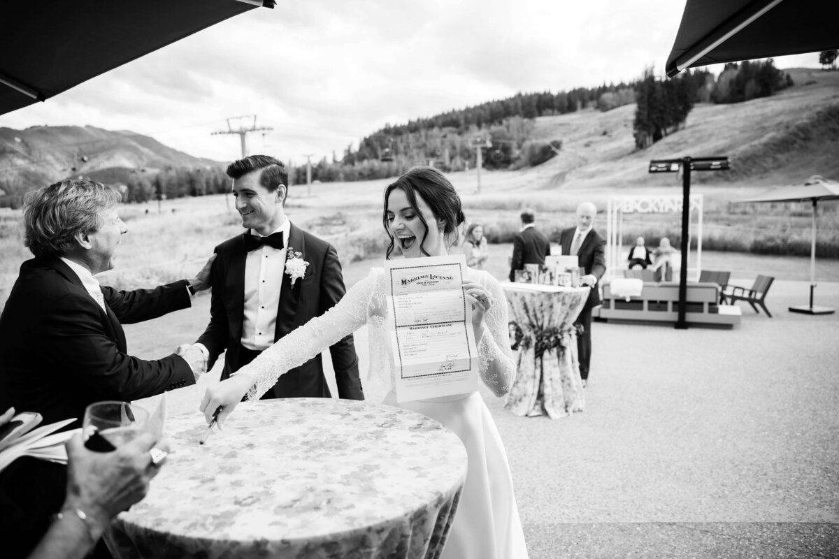 bride and groom showing off marriage license