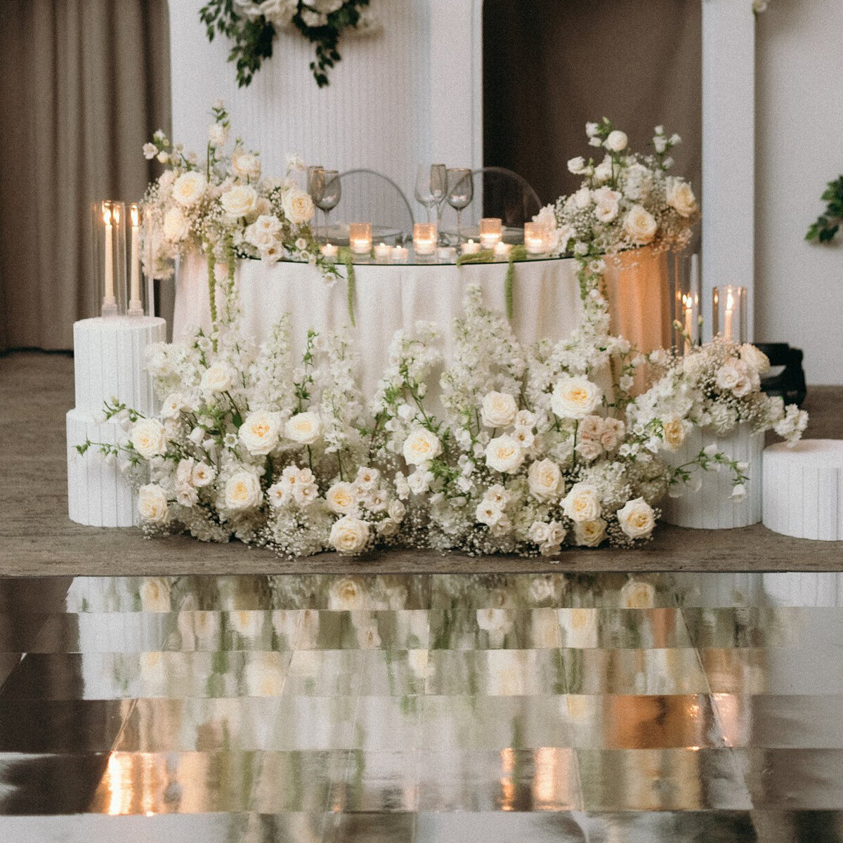 Elegant meadow of white flowers for a romantic sweetheart table at the Westbury Ballroom.