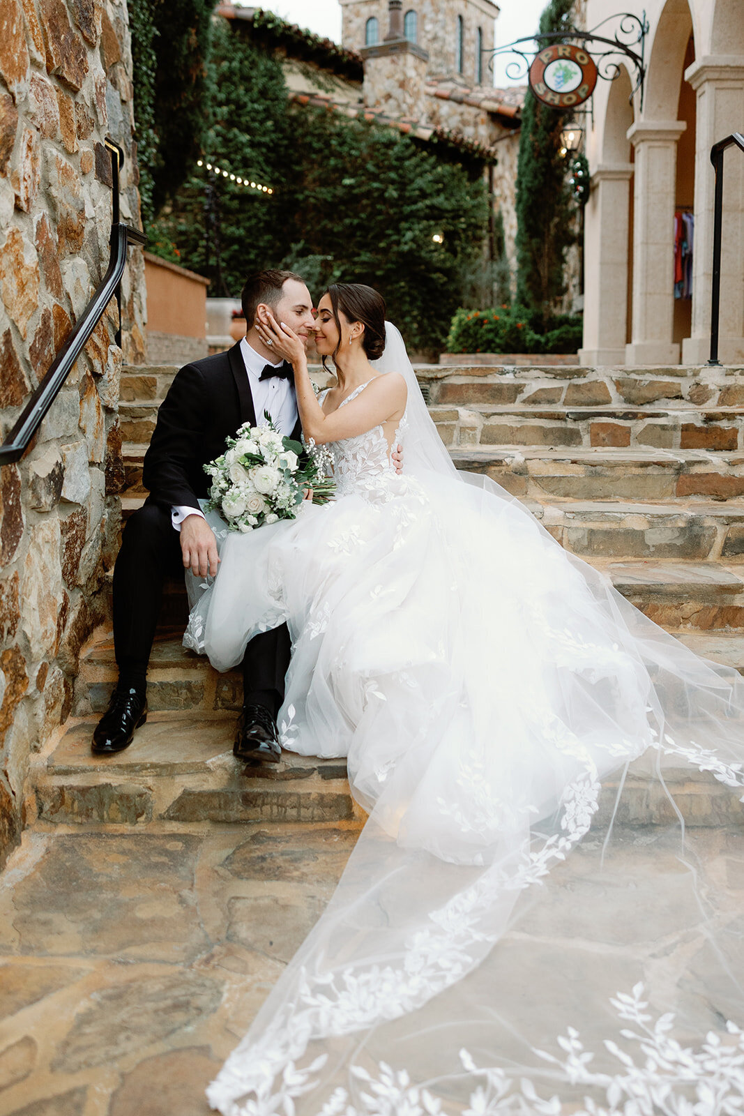 bride and groom on stairs at bella collina weddings & events​