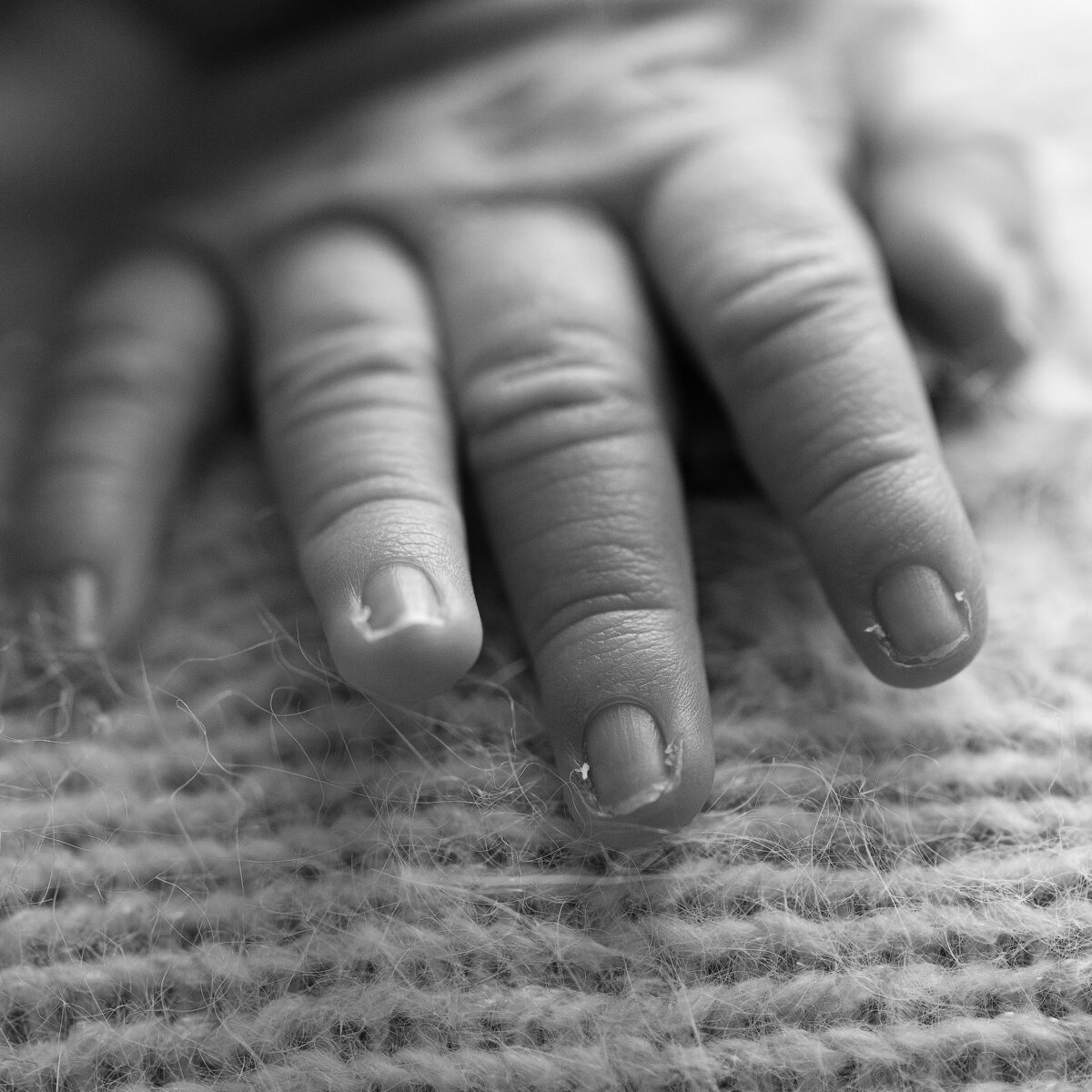 A beautifully raw macro photo of a newborn’s fingers—each tiny line and flake a part of their perfect beginning.