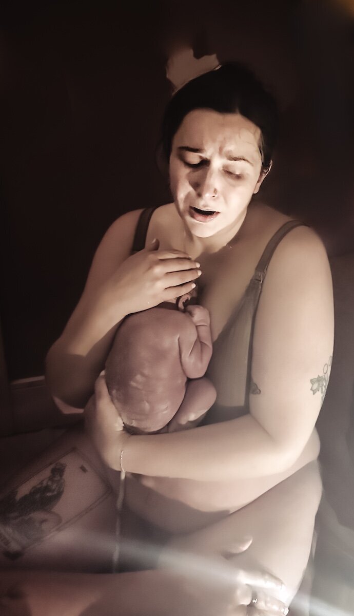 an Edmonton mom holding her baby after giving birth