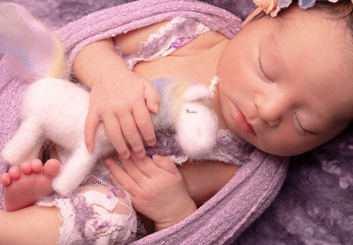 Newborn sleeping with their stuffed animal