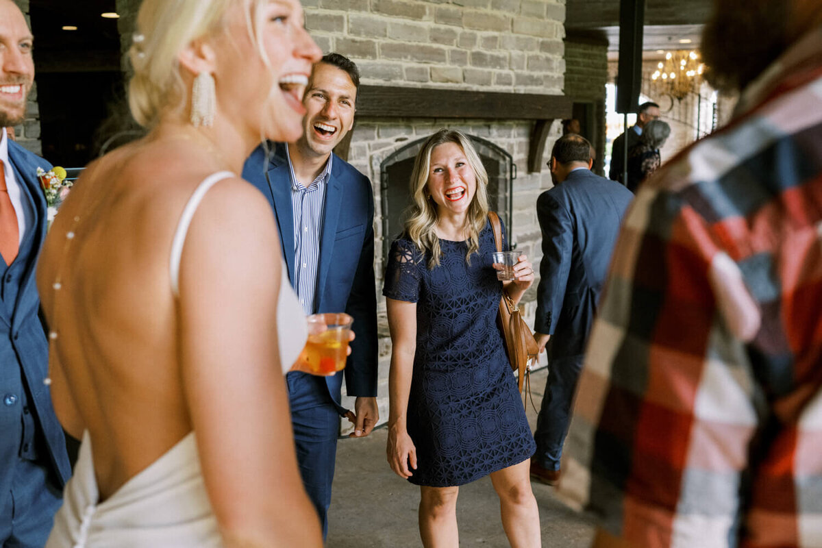 guests-laughing-during-reception-with-bride