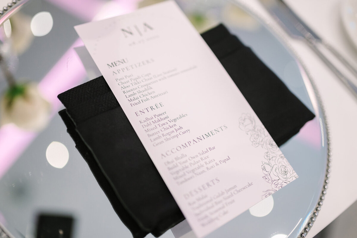 Black and white wedding menu for guests at wedding reception.