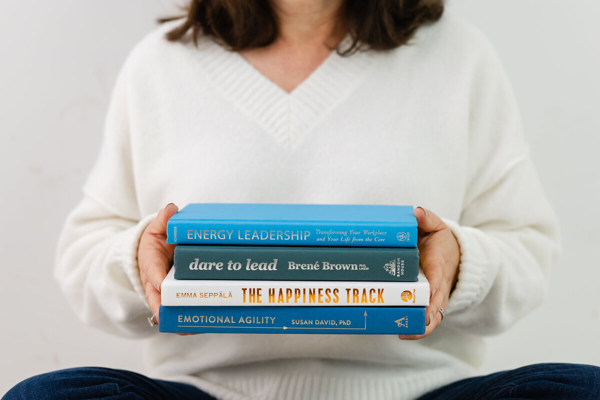 Stack of leadership and mindset books symbolizing growth and emotional resilience